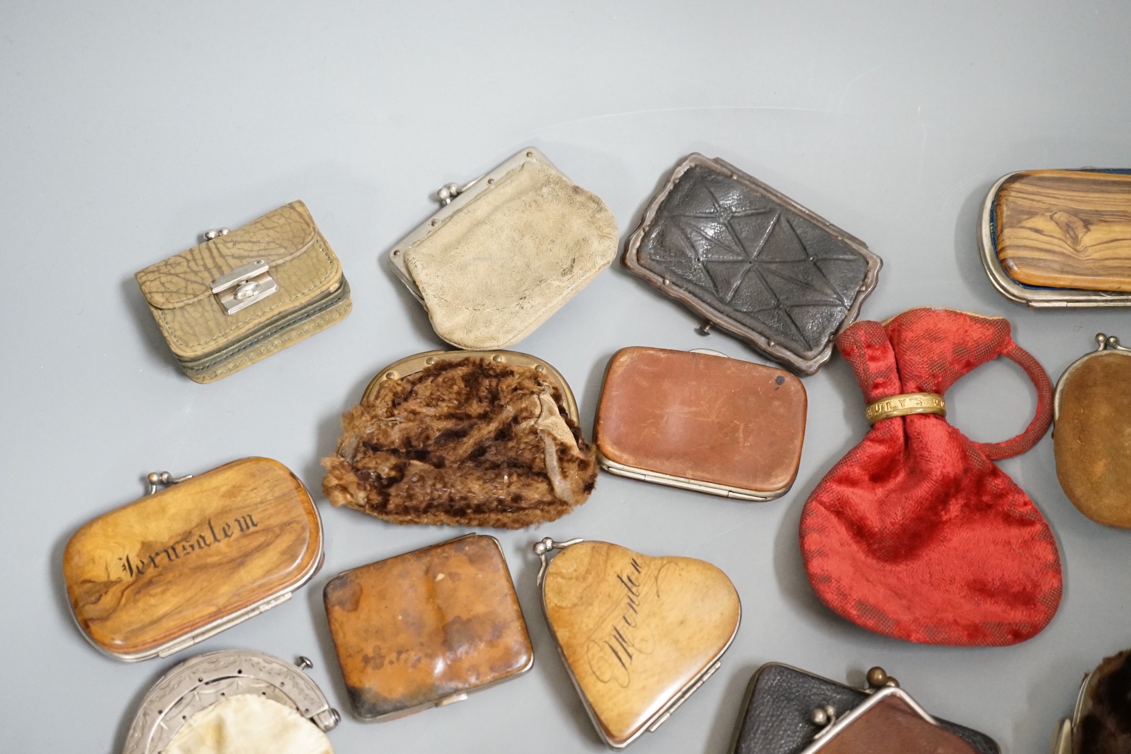 A collection of mostly Grand Tour, wooden souvenir purses and other 19th and 20th century leather and fur purses